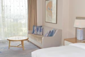 a living room with a couch and a table at Le Meridien Suzhou, Suzhou Bay in Suzhou