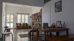 a living room with a table and a book shelf at Golpo - Stories and Stays in Dibrugarh