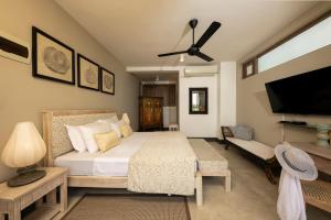 a bedroom with a bed and a flat screen tv at Arahtis Lake Villa in Hikkaduwa