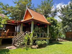 a house with a gazebo in a yard at Khmer Oasis on the Lake 