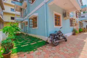 a motorcycle parked in front of a building at Holy Cross Home Stays in Old Goa