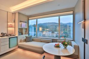 a living room with a couch and a table at Narada Grand Hotel Zhejiang in Hangzhou