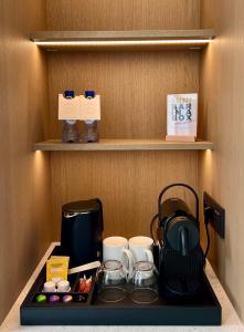 a cupboard with a coffee maker and tea at OPO Hotel in Brussels