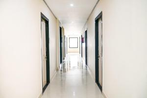 an empty corridor in a hospital with doors open at Flagship Vj Inn Nagamalli Thota in Kākināda