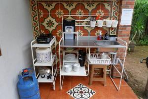 a kitchen with a sink and a counter with dishes at Rumah Canda in Bandung