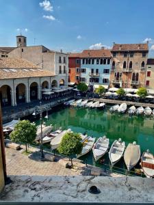 a group of boats are docked in a harbor at Splendid Lake 3 in Desenzano del Garda