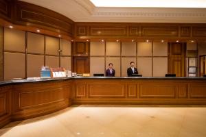 two men sitting at a bar in a courtroom at City Hotel Shanghai in Shanghai +30 photos