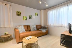 a living room with a couch and a table at FL Residence Shinjyuku I in Tokyo