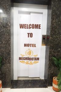 a door with a welcome to hotel melbourne sign on it at Hotel Shree Meghdootam in Bhopal