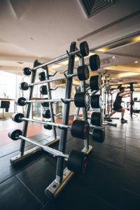 a gym with a bunch of weights at City Hotel Shanghai in Shanghai