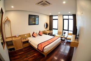Habitación de hotel con cama y espejo en Gia Le Hotel, en Tam Ðảo