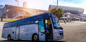 a blue bus parked in front of a building at Shangri-la Guangzhou -3 minutes by walking or free shuttle bus to Canton Fair & Overseas Buyers Registration Service in Guangzhou
