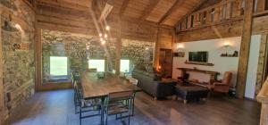 a living room with a wooden table and a couch at Ferme à Marius in Champéry