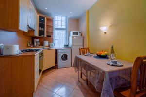 uma cozinha com uma mesa com um prato de fruta em Romeo Family Apartments em Taline