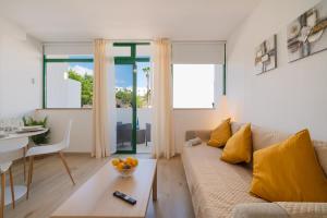 a living room with a couch and a table at Lanzahost Carmenes Comfort in Costa Teguise