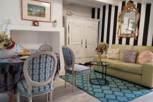 a living room with a couch and a table at Maison avec jardin Honfleur in Honfleur