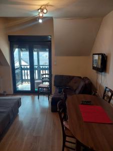 ein Wohnzimmer mit Sofa und Tisch in der Unterkunft JollyKop Vila Valentina A14 in Kopaonik