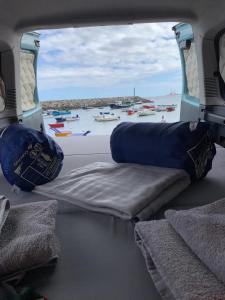 a view of the back of a boat with a view of the ocean at CamperTF - old but lovable mini caravans in Tenerife in El Médano