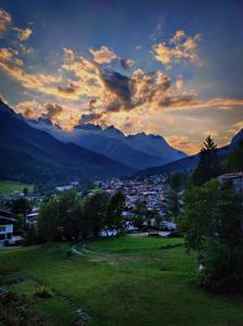 a view of a town in a valley with mountains at Vista mozzafiato sulle Dolomiti Friulane in Forni di Sopra