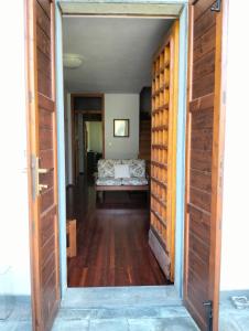 an open door leading into a room with a couch at Vista mozzafiato sulle Dolomiti Friulane in Forni di Sopra