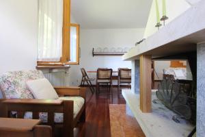 a living room with a couch and a fireplace at Vista mozzafiato sulle Dolomiti Friulane in Forni di Sopra