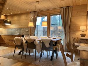 a dining room with a table and chairs with lights at VILLA TUNDRA in Ruka