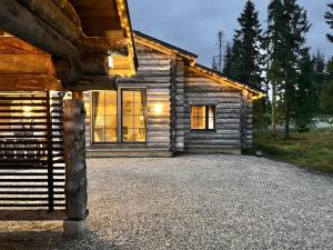 a log cabin with lights on the side of it at VILLA TUNDRA in Ruka