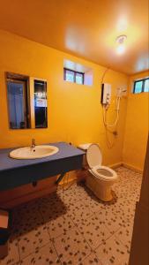 a bathroom with a sink and a toilet and a phone at Sweet Jungle Bungalows in Koh Rong Island