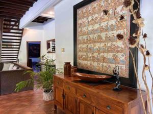 a bathroom with a sink on top of a wooden dresser at Bali Berg Villa, Sanur in Sanur