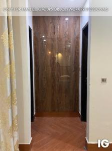 a hallway with a glass door in a room at Spacious 3 Bedroom Furnished Family Home near Valencia Town, Lake City & Ring Road in Lahore