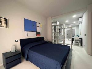 a bedroom with a blue bed in a room at Casaincentro civitanova in Civitanova Marche