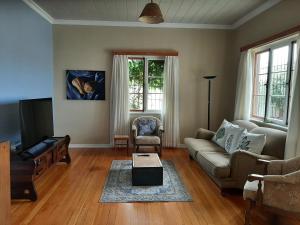 a living room with a couch and a table at Japie's Yard Self-Catering in Swakopmund