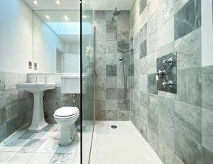 a bathroom with a toilet and a sink and a shower at Museum ST Central Soho Apartment in London