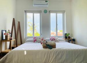 a bedroom with a large bed with a basket on it at HOMEY Homestay Hue 