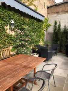 a wooden table and chairs on a patio at Ferienwohnung in Werder Havel Innenstadt in Werder