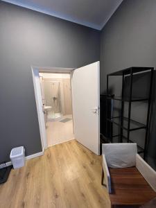 a room with a bathroom with a toilet and a door at Centro Hostel in Vilnius