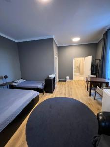 a hotel room with two beds and a table at Centro Hostel in Vilnius