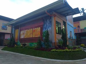 a house with a painting on the front of it at Happy Daze Hotel Tagum in Tagum