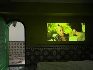 a tv on top of a bed in a room at The Arabian Nights B&B in Chongqing