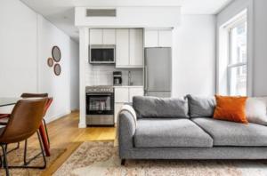 a living room with a couch and a kitchen at Relaxing 3BR Apartment in New York