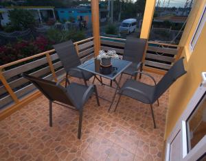 a patio with a table and chairs on a balcony at Hibiscus chez Arielle in Rodrigues Island