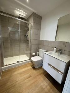 a bathroom with a shower and a toilet and a sink at 1 Bed Apartment near Old Trafford with free car park in Manchester
