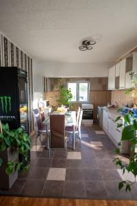 a kitchen and dining room with a table and chairs at 5 Bedrooms Luxury Apartment Villa in Bucharest