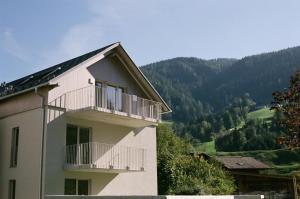 a building with a balcony on the side of it at BASECAMP Reiteralm in Pichl