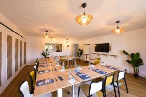 a conference room with long tables and chairs at Kyriad Villeneuve Saint Georges in Villeneuve-Saint-Georges