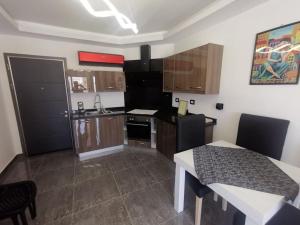 a small kitchen with a table and a kitchen gmaxwell gmaxwell gmaxwell gmaxwell gmaxwell gmaxwell gmaxwell at SUNNY BEACH resort apartment for rent in Montazah in Sharm El Sheikh