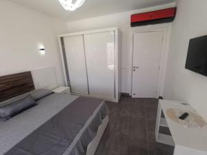 A bed or beds in a room at SUNNY BEACH resort apartment for rent in Montazah