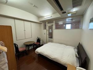 Postel nebo postele na pokoji v ubytování ホテルカスカベ Hotel Kasukabe