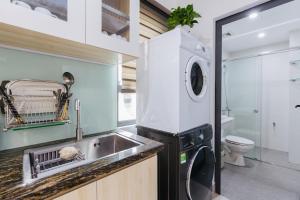 a kitchen with a sink and a washing machine at 9 LIGHT APARTMENT in Hanoi