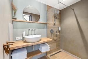 a bathroom with a sink and a shower at Beachrooms Pier 7 in Vlissingen